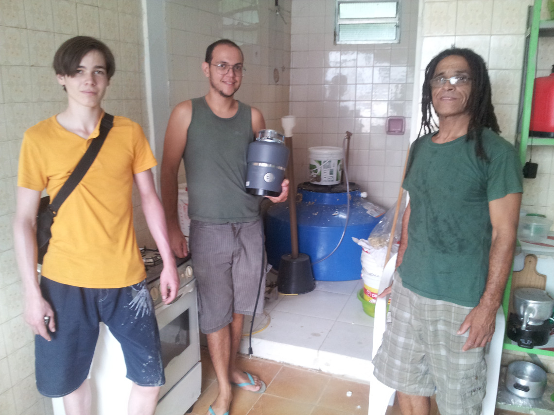 Jorma, Rafael and friends from Alemao in front of the kitchen biodigester