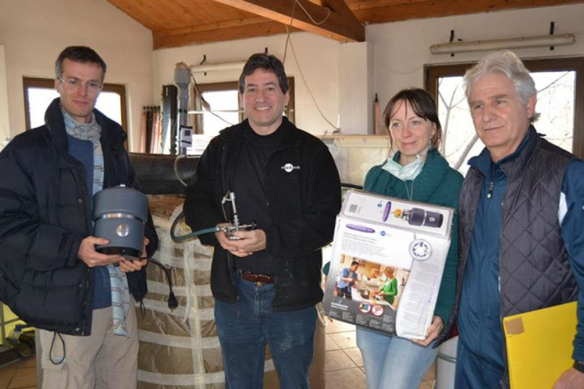 Simon Westermann, Culhane and the science team at Damanhur receiving the Insinkerator that Culhane was able to get from the company as a gift to the project research