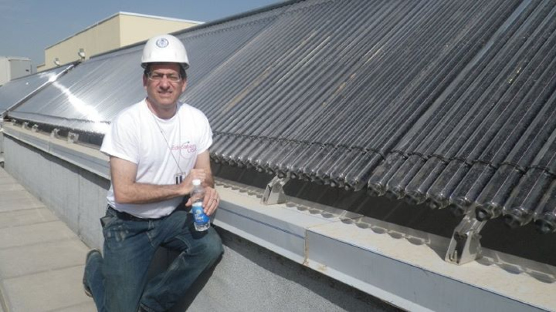 Culhane on the roof of the new US Embassy in Baghdad exploring their vacuum tube solar hot water system.