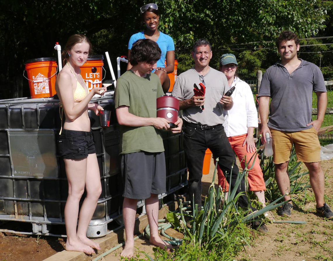 The Envisaj Mercy team (Mercy College Environmental Sustainability and Justice League) finishing up the Solar CITIES IBC digester at the Kelsey house