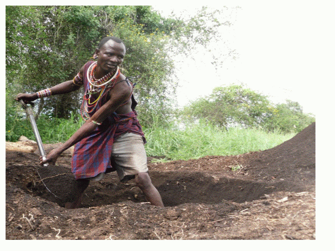 A Maasai warrior digs a pit for the biodigester he is building with Solar CITIES