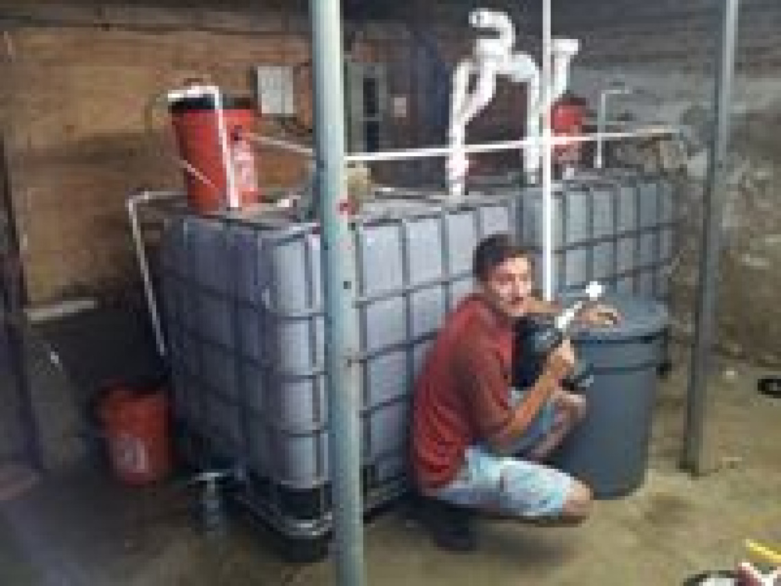 Culhane puts finishing touches on a basement biodigester being experimented with at the home of the Rockefeller/Lindstrom family at Mud Creek Farm