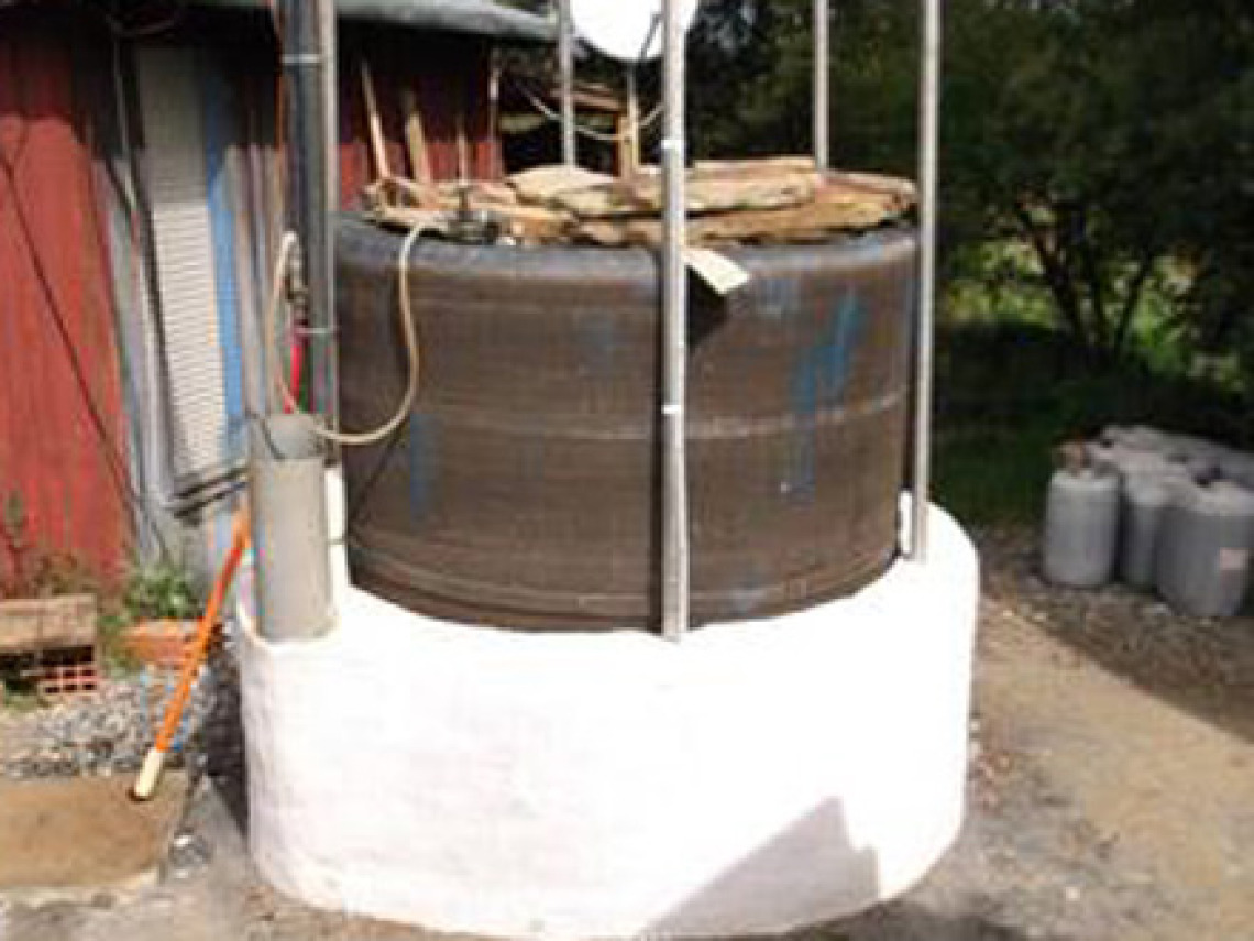 A Solar CITIES modified ARTI digester at the Tamera Solar Kitchen using concrete culverts for the digester body and a water tank for the gas collector.