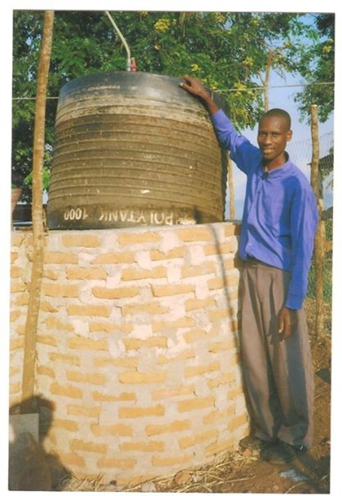 Joram Samoan with his biodigester by Lake Tangankiya in Kigoma